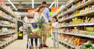 Parents and daughter shopping in grocery store